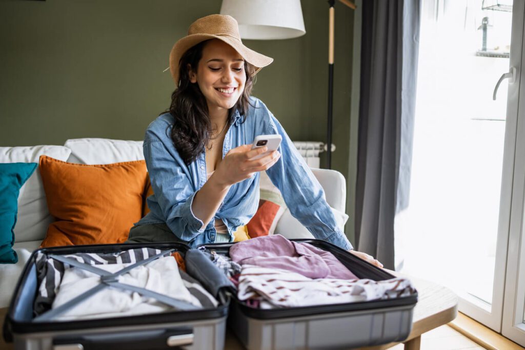 here is a picture showing a happy traveler packing for a holiday after securing a good price on a cruise 